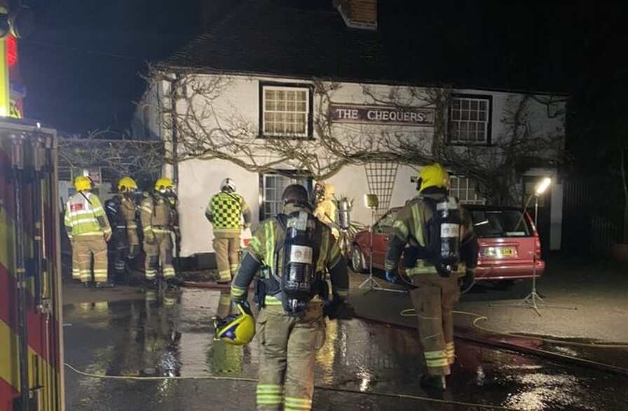 Firefighters at the scene of the outbuilding blaze at The Chequers Inn