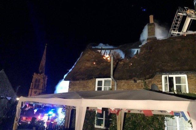 Firefighters tackle the fire in the Grade II listed thatched building