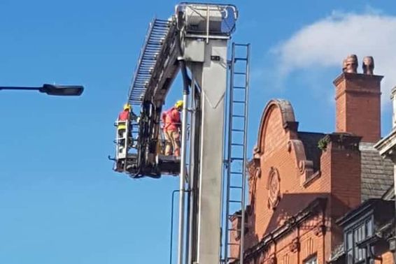 Firefighters using aerial equipment to tackle the blaze.