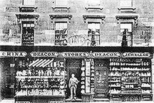 Photograph of the Wood Street shop front as it was in 1902 with Hubert Deacon standing in the doorway.