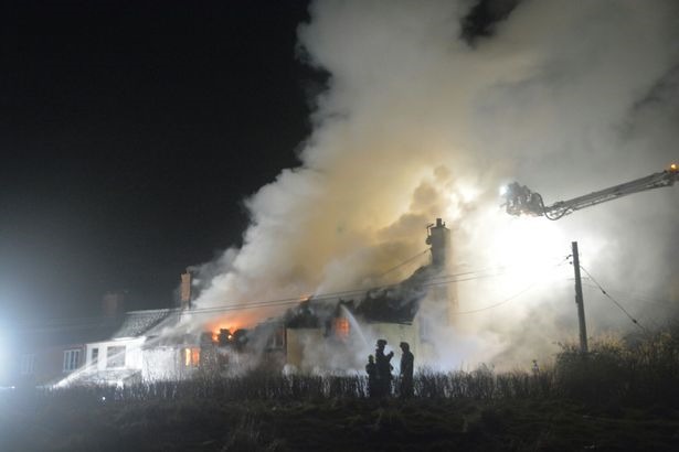 Fire devastates the two Grade II houses in Sowton, Devon.