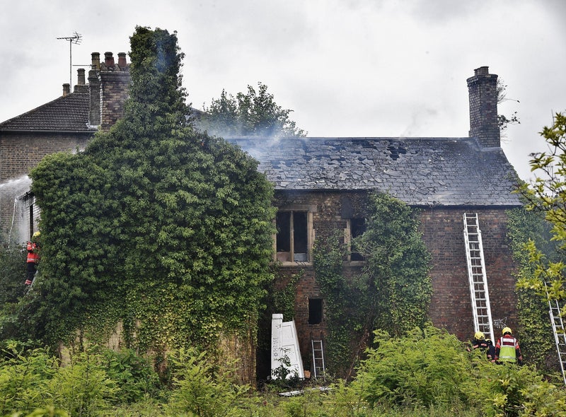 Firefighters tackling the blaze at a derelict house in Peterborough