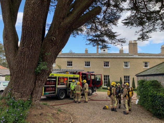 Firefighters outside Gunton Hall in north Norfolk, where a fire broke out on April 11, 2019.