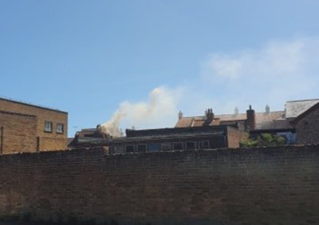 Smoke rises from the building in Market Row