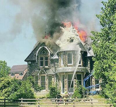 Flames leap from the roof of Dolgerddon Hall in Rhayader on Monday afternoon