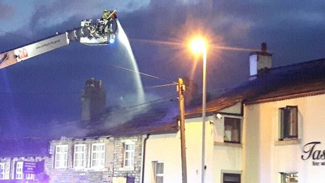 Firefighters tackle a fire at Features Beauty Clinic in Almondbury (Picture: Brian Ruttle)