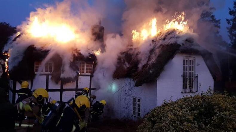 Firefighters tackle a thatch blaze near Alresford. Picture by Hampshire Fire and Rescue.
