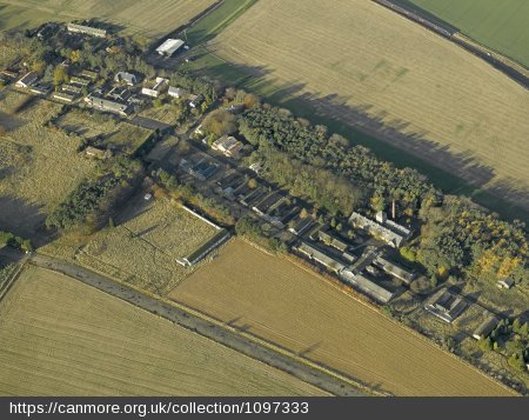 Oblique aerial view centred on the former hospital, taken from SE