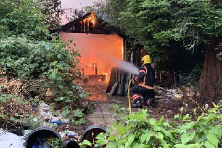Firefighters tackling the shed fire at Ely House