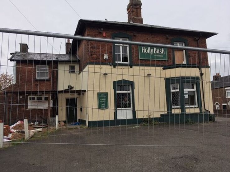 The Holly Bush pub, in Northwood, is now covered by metal fencing