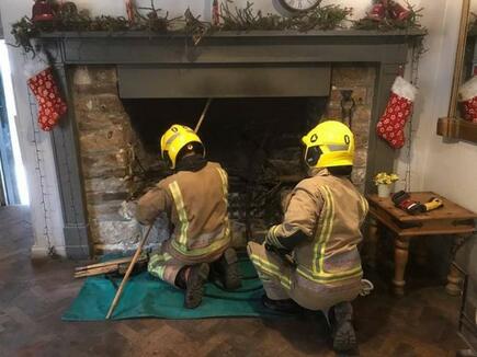 Firefighters use a chimney kit to extinguish the flames 