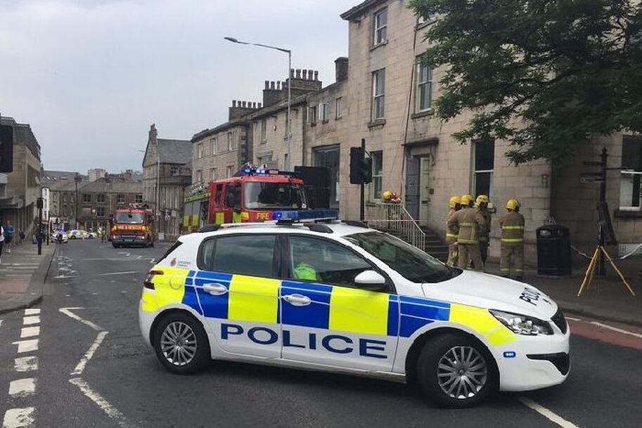 The Grade II listed house is where the firefighters are congregated, with the salon next to the fire engine. (Image: BBC Radio Lancashire)
