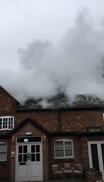 Smoke rises from the roof of the historic Offley Arms 
