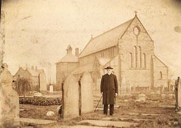 Canon J. Bridger outside Church of All Saints, Rainford c1900 before its tower was built.