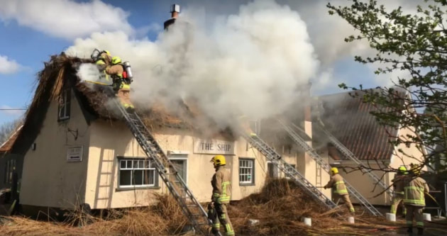 The fire has engulfed the thatched roof of The Ship Inn