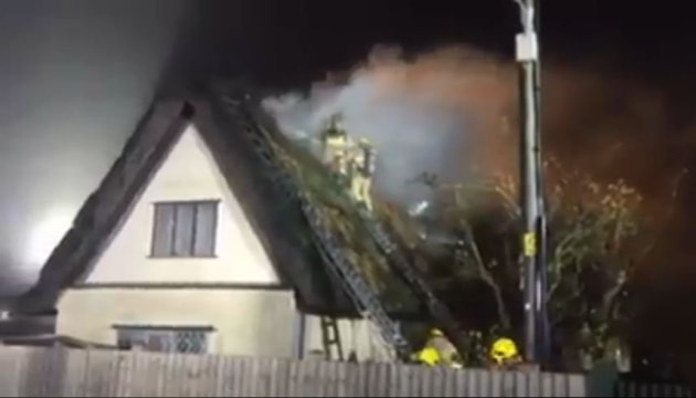 Fire fighter could be seen fighting the blaze on top of the house.